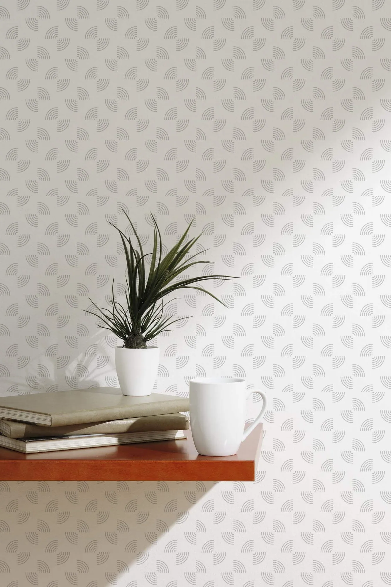 Abstract geometric semi-circle wallpaper in a room setting: pale gray striped semicircles rotate through a white-ground repeat
