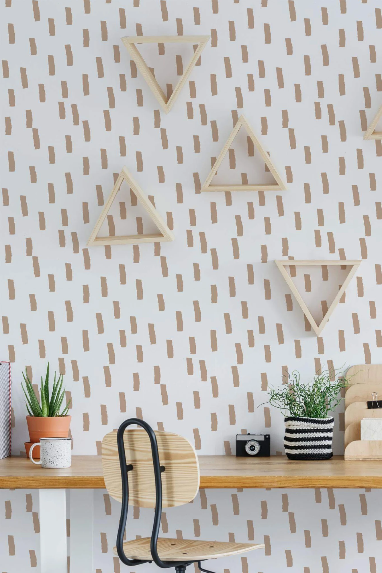 Beige brush stroke lines wallpaper in a room setting: small beige brush marks on white. A printed pattern, not plaster or linen