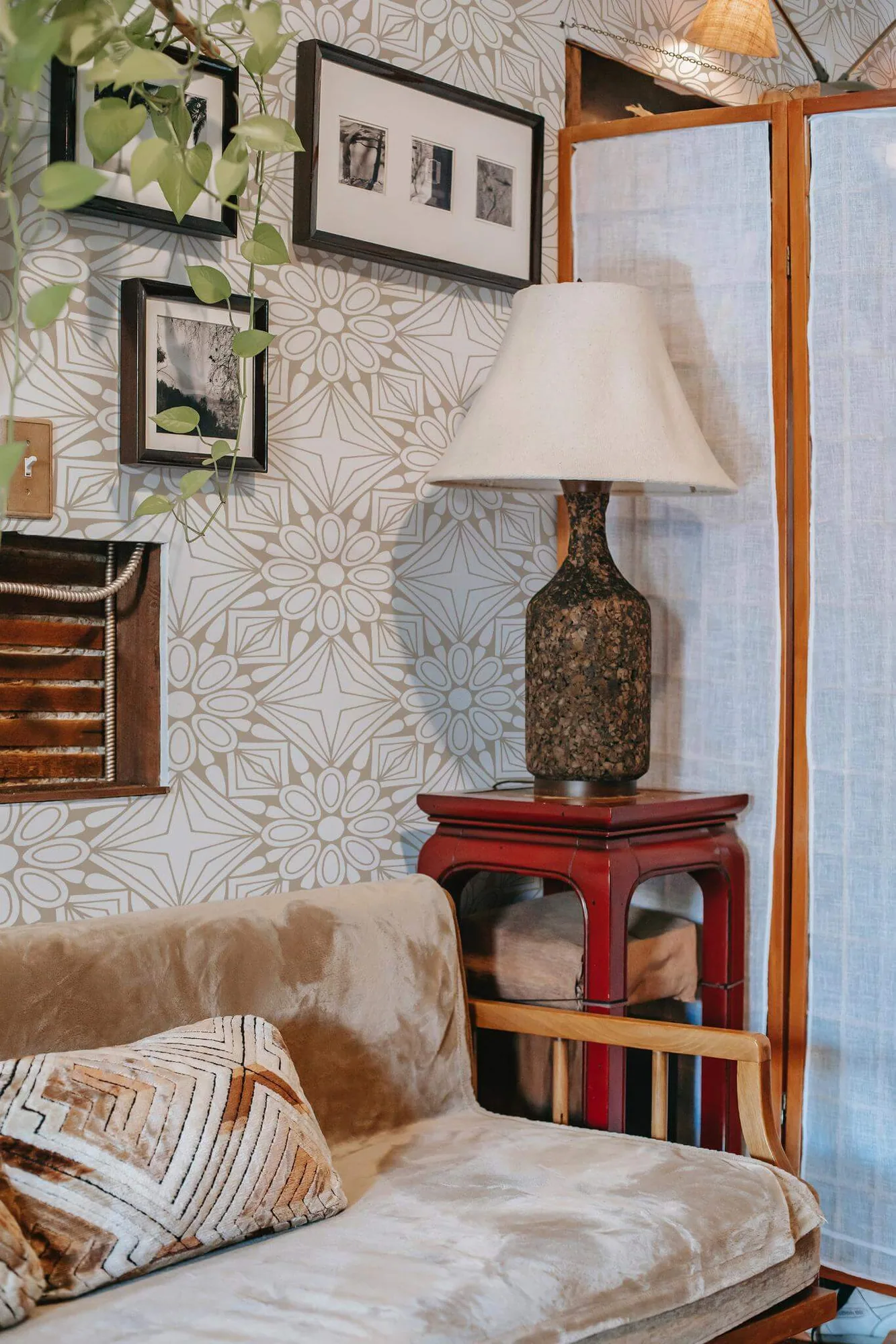 Beige geometric floral wallpaper in a room setting: large beige floral medallions meet edge to edge on white