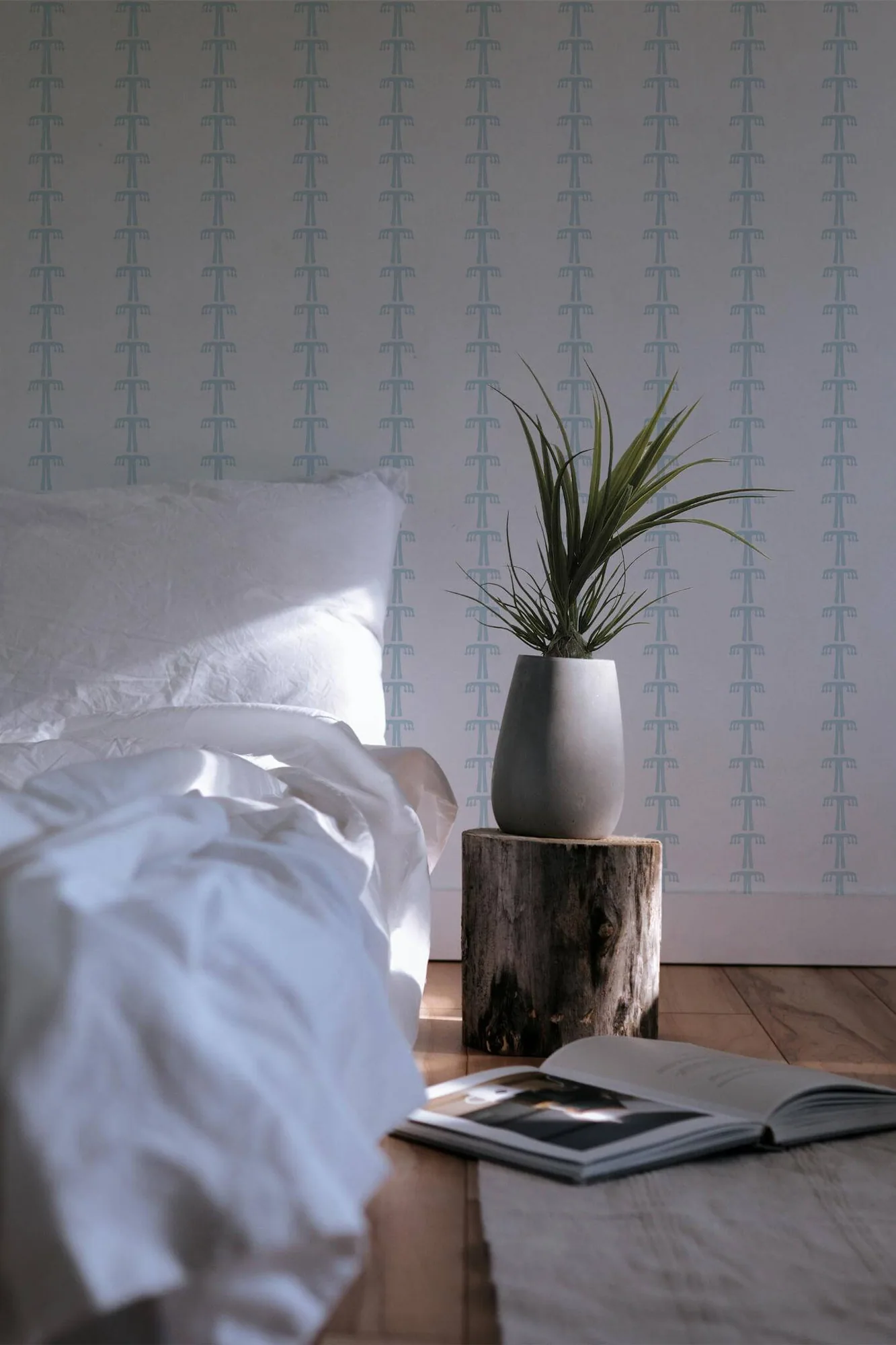 Blue boho wallpaper in a room setting: small pale-blue tree-like marks sit in loose vertical rows on white