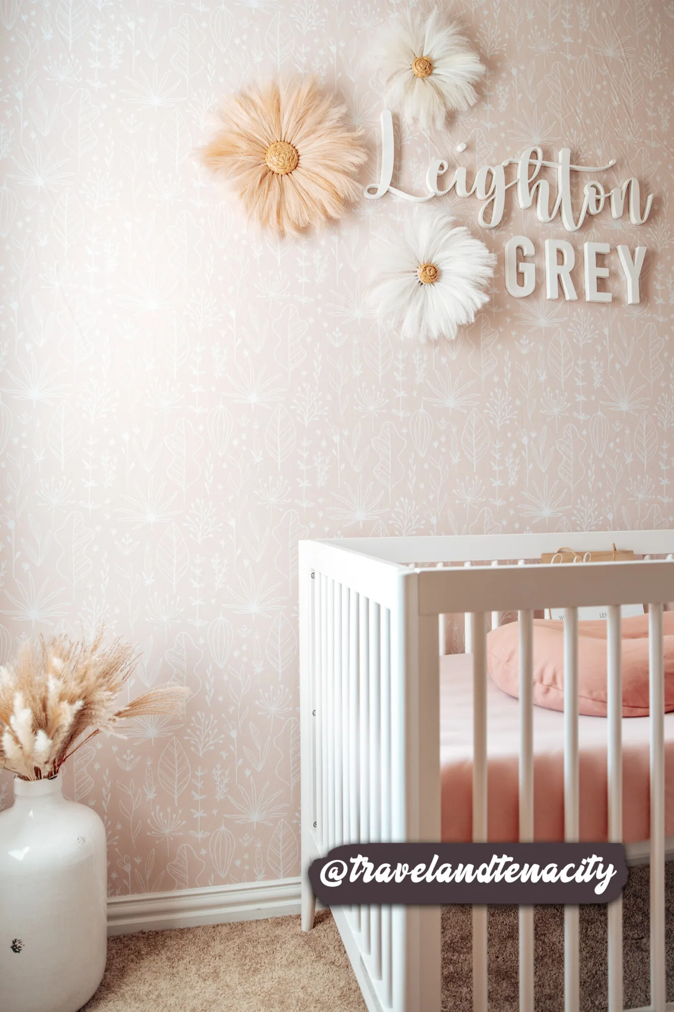 Pink boho wallpaper in a room setting: white botanical line drawings sit on a soft blush-pink ground