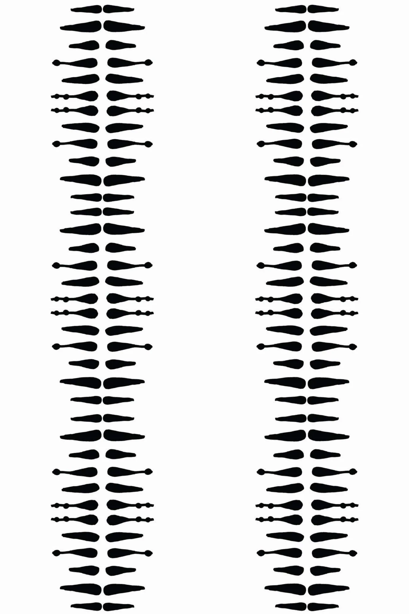 Boho stripe wallpaper pattern close-up: broken black brush marks stack into narrow vertical stripes on white