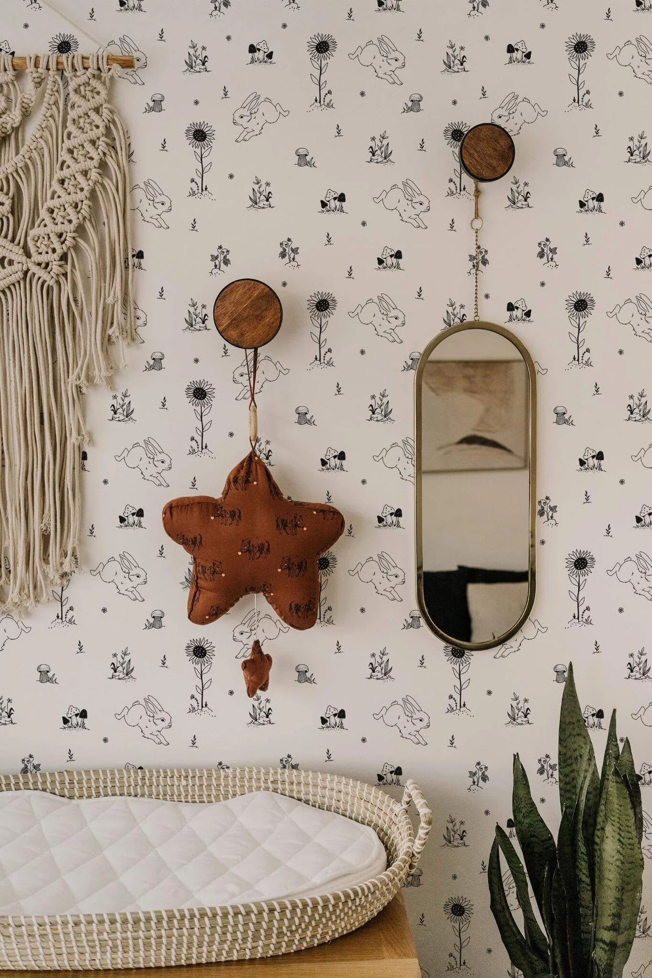 Bunny nursery wallpaper in a room setting: black-and-white woodland rabbits and small botanical motifs