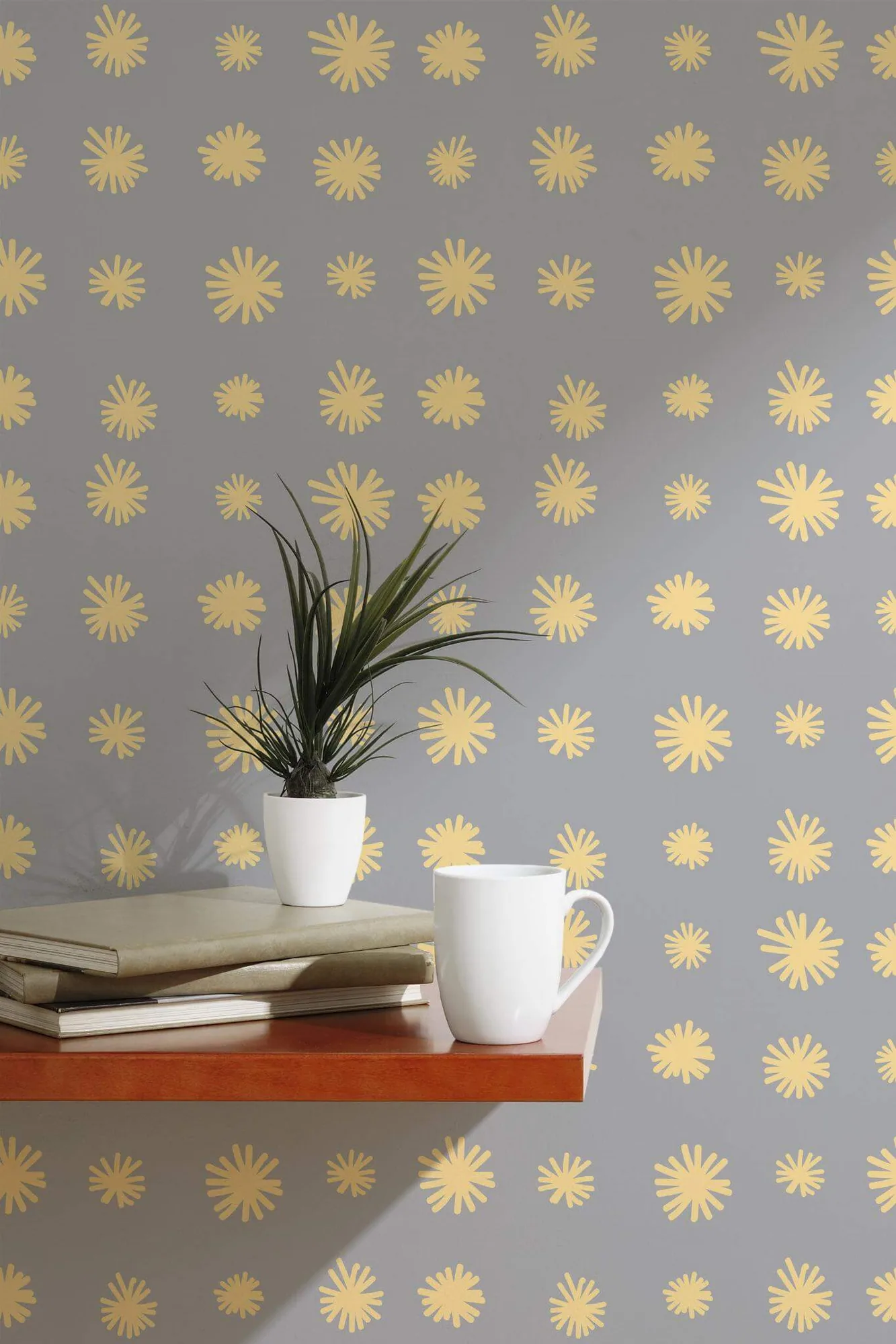 Dandelion flower wallpaper in a room setting: small yellow dandelion-like bursts spaced across a gray ground