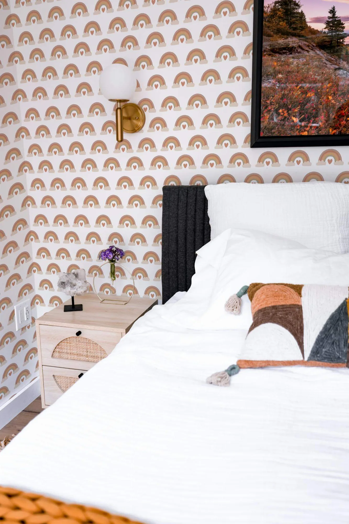 Neutral rainbow wallpaper in a room setting: quiet beige rainbows with small hearts and clouds