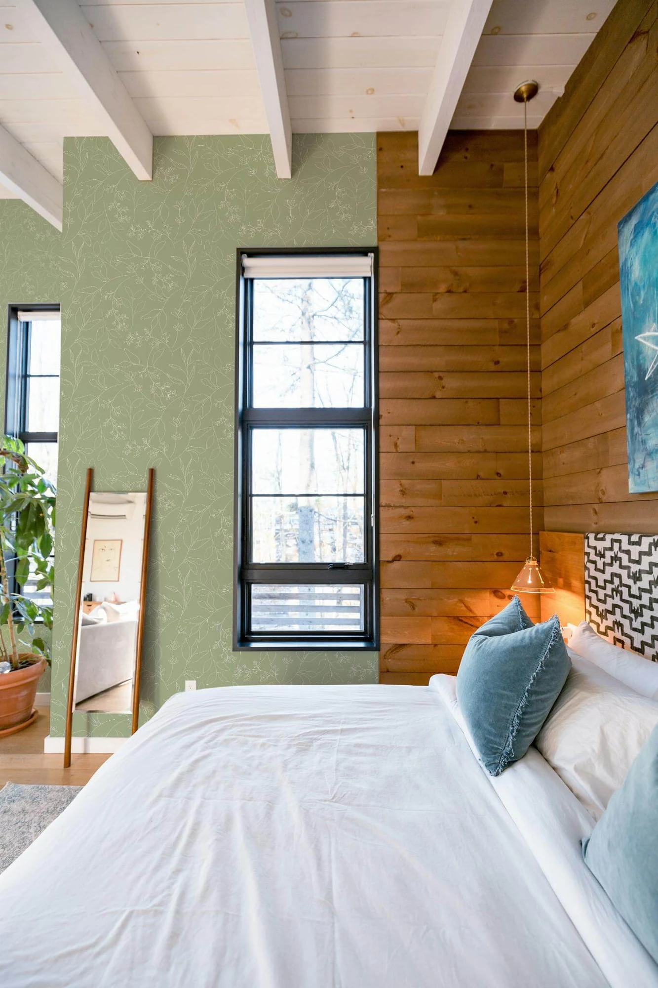 Sage green leaf wallpaper in a room setting: fine white leaf outlines on sage green