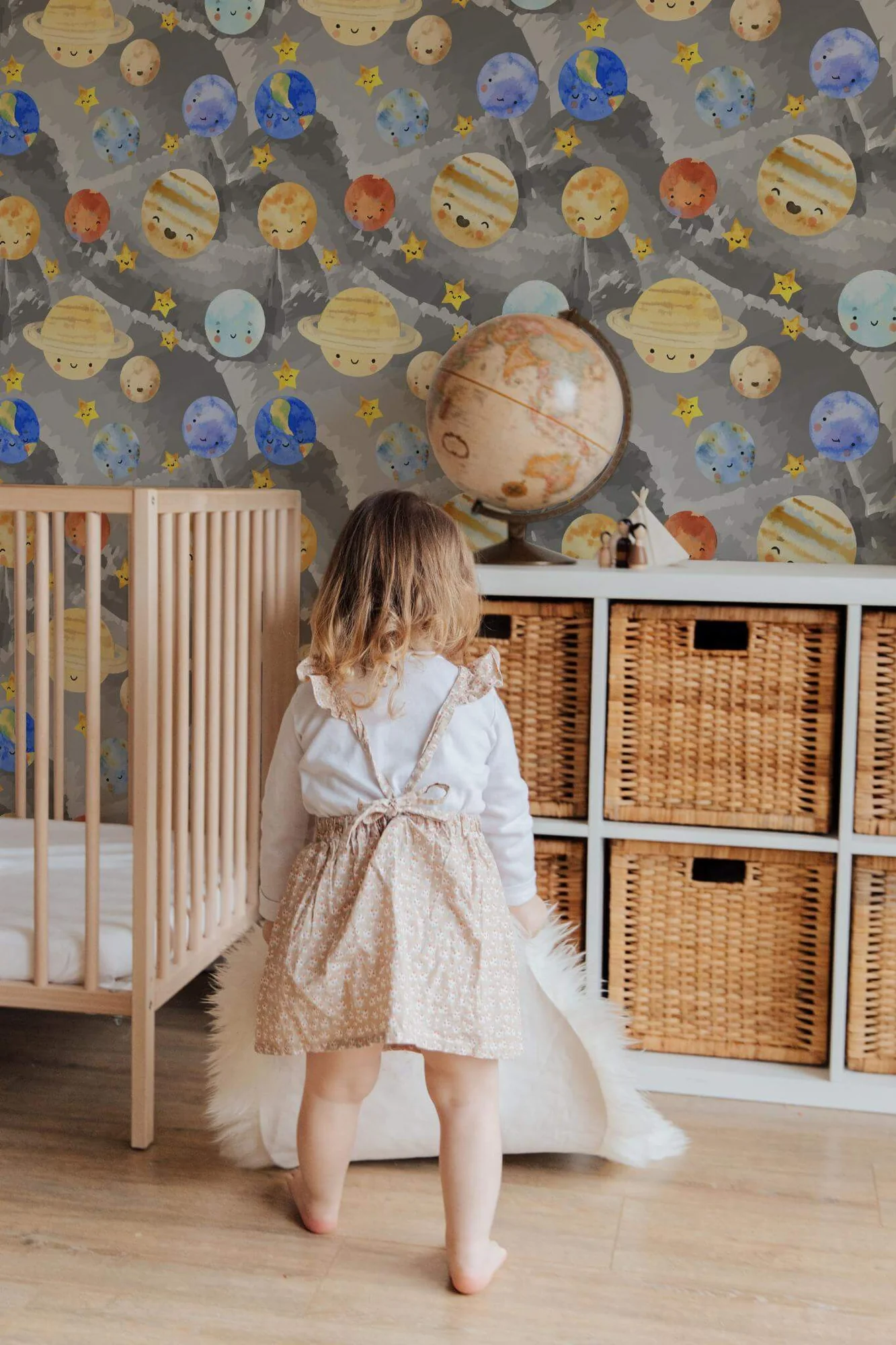 Watercolor solar system wallpaper in a room setting: smiling planets and stars in a loose watercolor solar system on warm gray